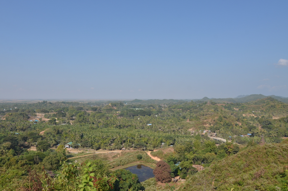 The bridge over the river is at the out most right in the image, the path to the temple leads by the small lake