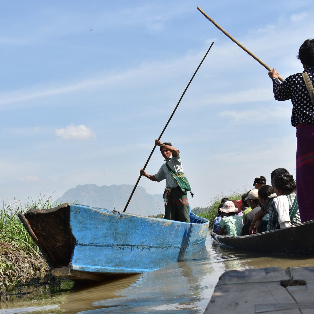 Travelling the narrow canals between the paddies requires a steady boat man