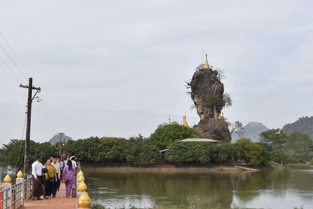 The temple is at the top of the rock, were the stupa is located